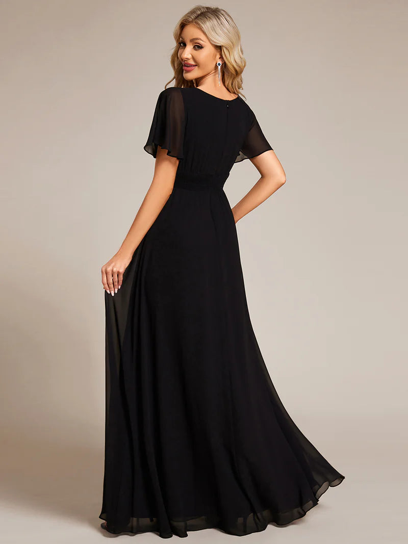 Round neck black bridesmaid gown in a pleated design for elegant wedding looks