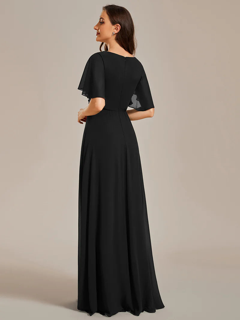 Elegant black bridesmaid dress with V-neckline, pleated skirt, and floral appliqués