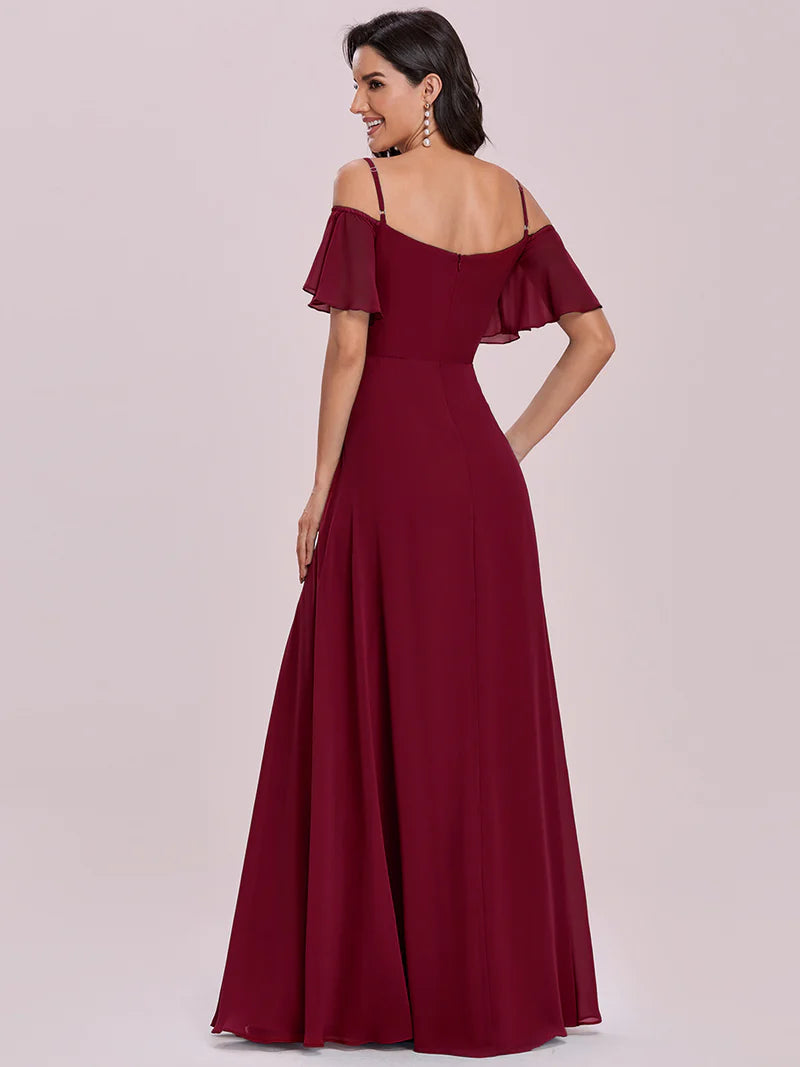 Burgundy off-shoulder evening gown on a plain background