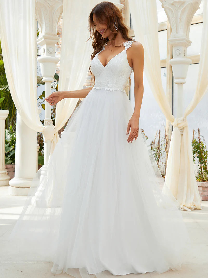 Romantic cream lace tulle wedding dress with double V-neckline and flowing skirt
