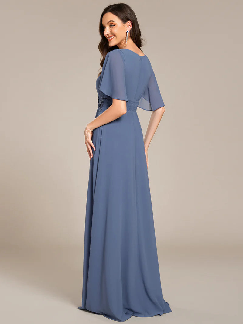 dusty a-line floor-length evening dress with short sleeves, pleated skirt, and applique embellishments
