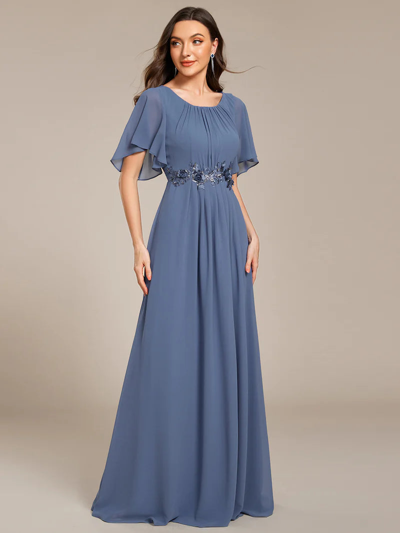 dusty a-line floor-length evening dress with short sleeves, pleated skirt, and applique embellishments