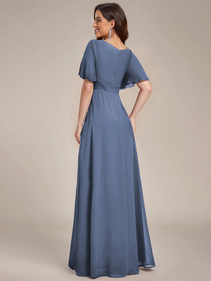 Round neck dusty blue bridesmaid gown in a pleated design for elegant wedding looks