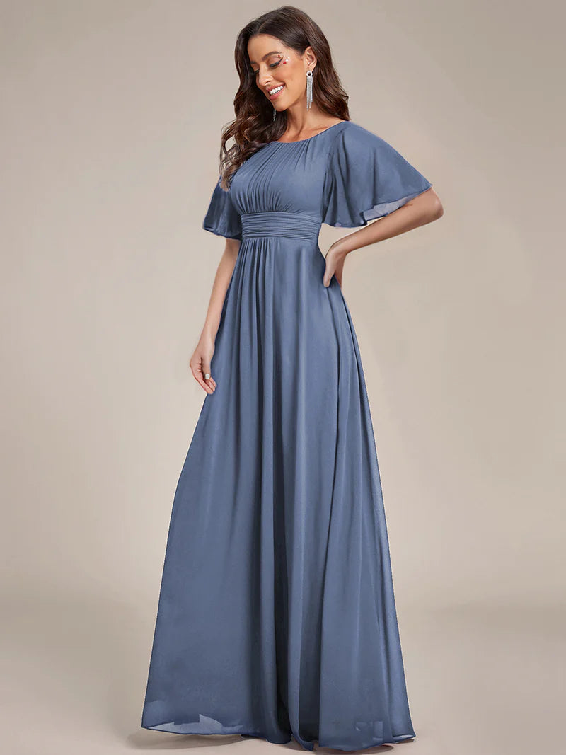 Round neck dusty blue bridesmaid gown in a pleated design for elegant wedding looks