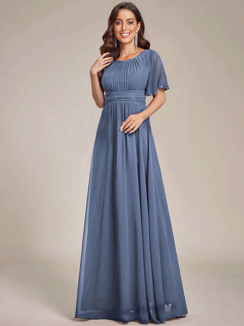 Round neck dusty blue bridesmaid gown in a pleated design for elegant wedding looks