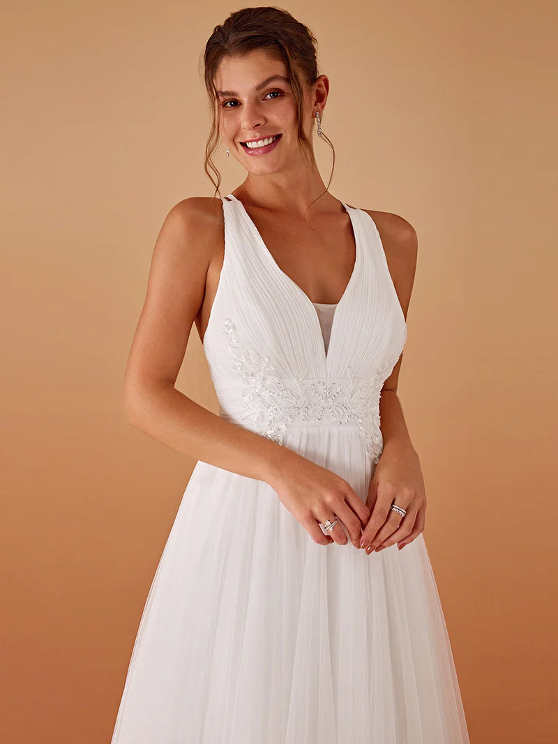 Elegant white mesh wedding dress with V-neckline, floral appliqués, and open back