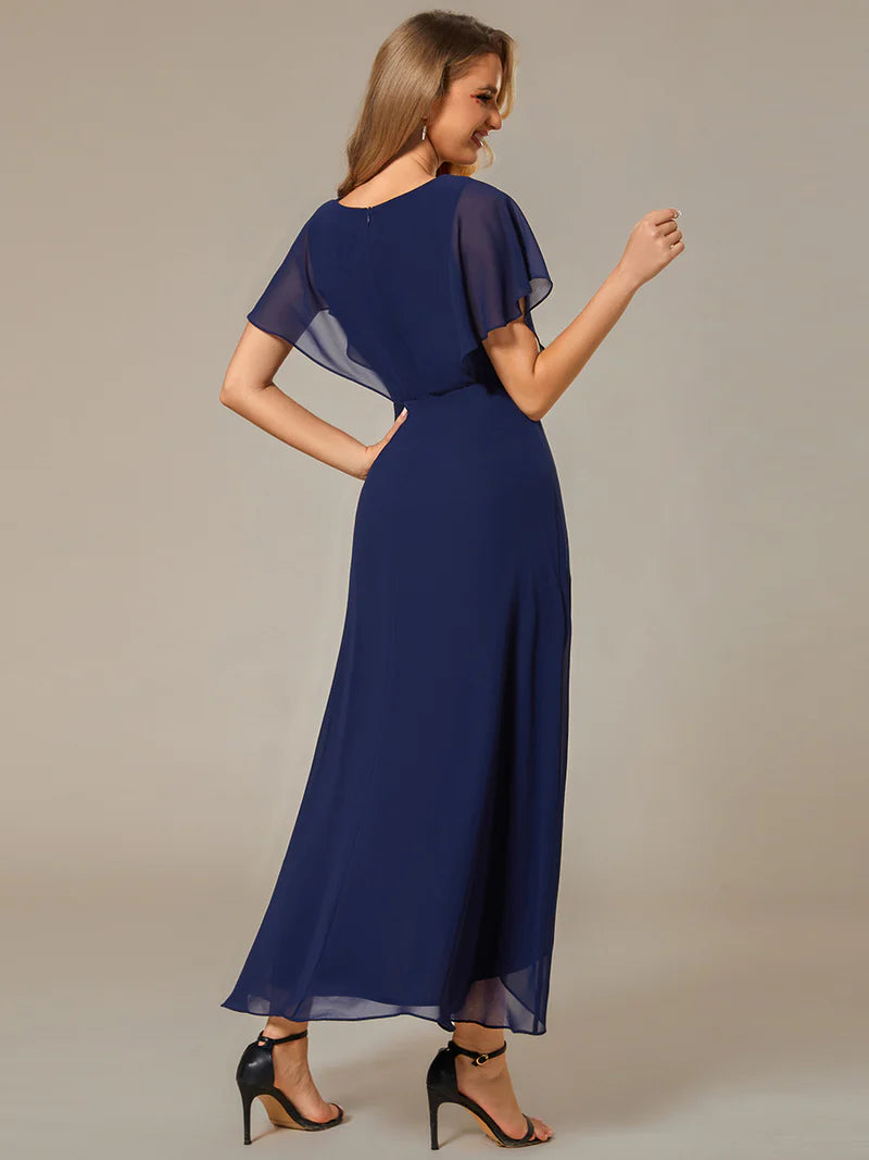 Elegant navy blue high-low gown with chiffon fabric, applique embellishments, and short sleeves