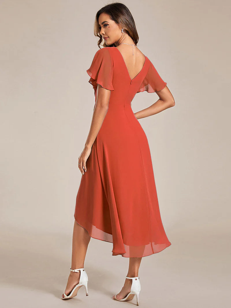Elegant chiffon wedding guest orange dress with pleated skirt and ruffle accents