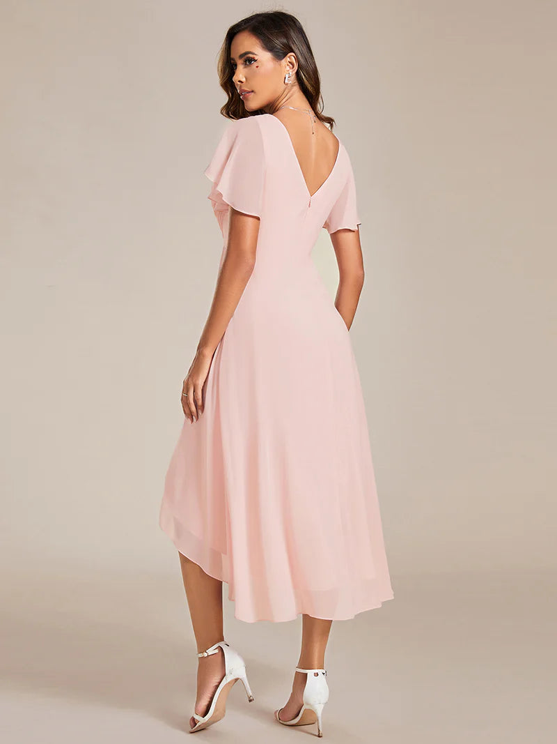 Elegant chiffon wedding guest pink dress with pleated skirt and ruffle accents