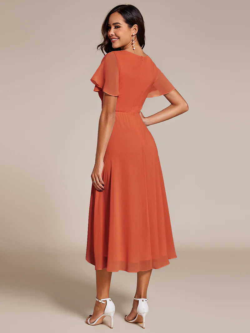 Elegant midi chiffon burnt orange dress with V-neck and ruffle sleeves, perfect for wedding guests
