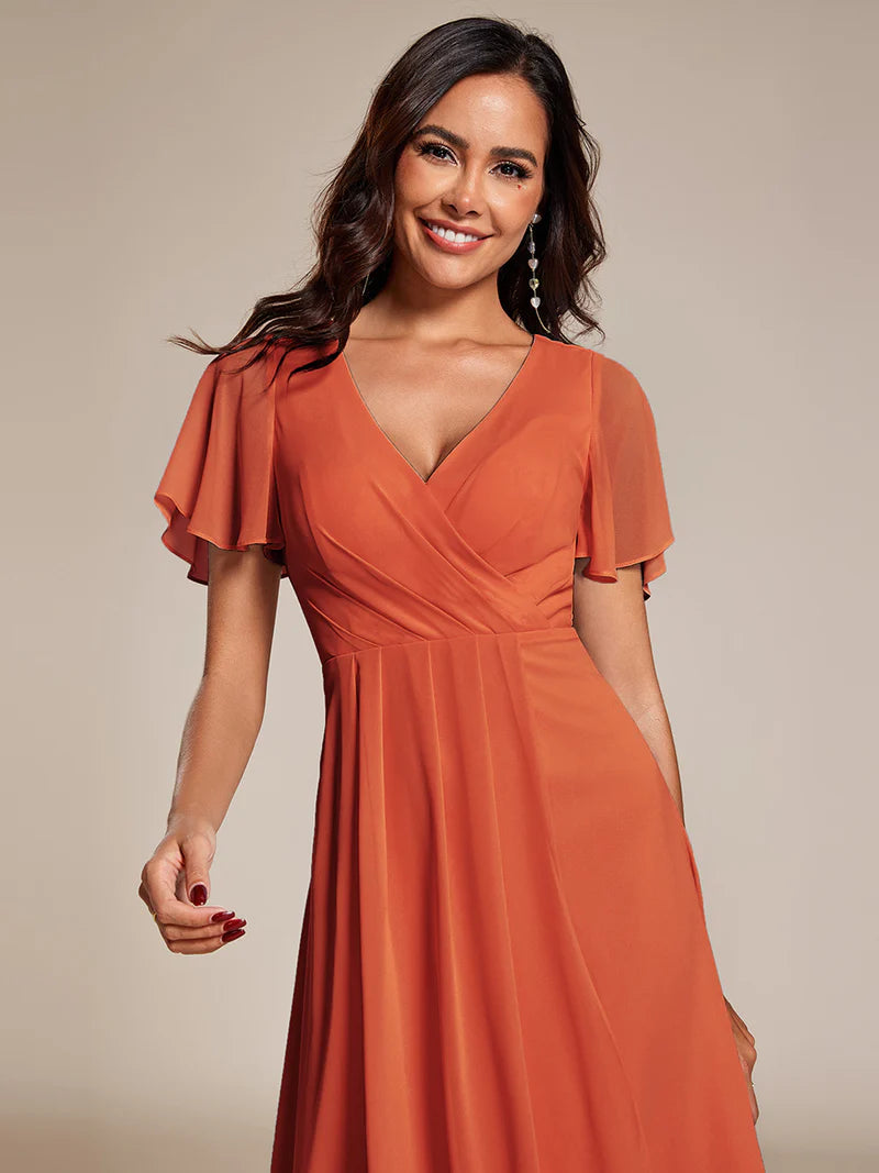 Elegant midi chiffon burnt orange dress with V-neck and ruffle sleeves, perfect for wedding guests
