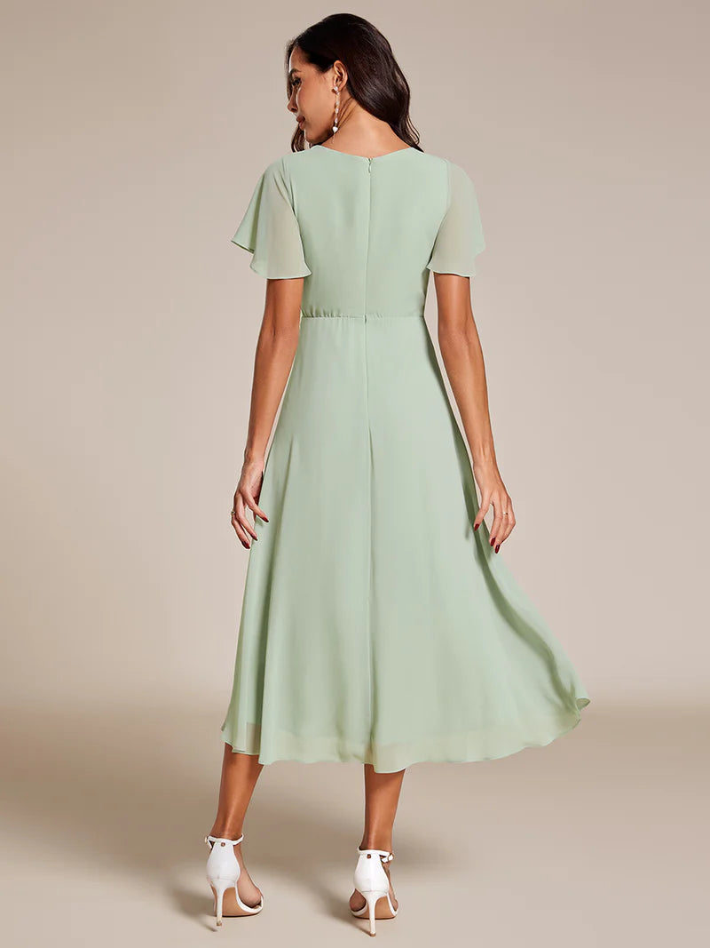 Elegant midi chiffon mint green dress with V-neck and ruffle sleeves, perfect for wedding guests