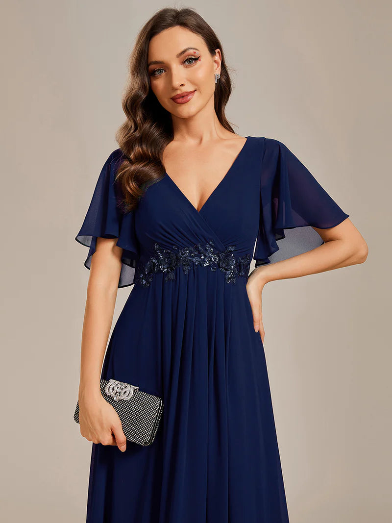 Elegant pleated bridesmaid navy blue dress with V-neckline and floral appliqués