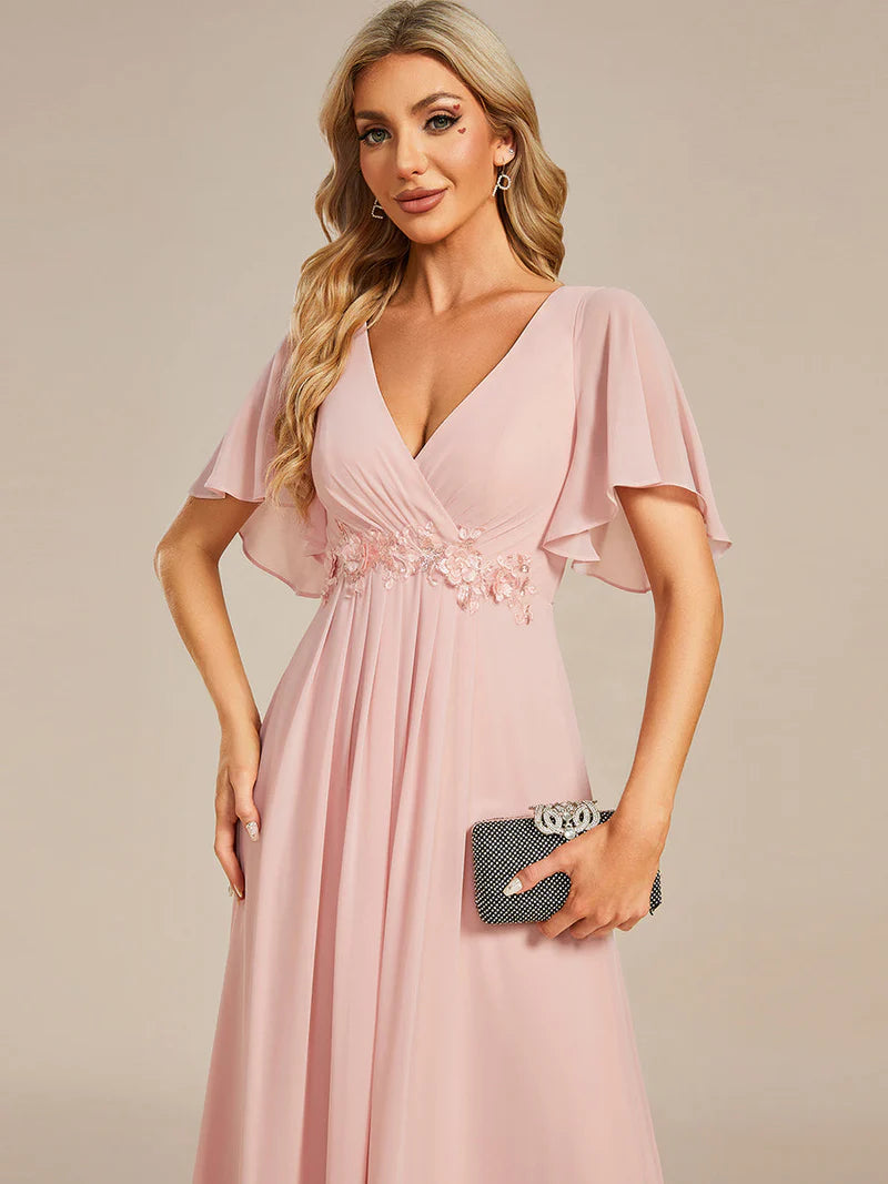 Elegant pleated bridesmaid pink dress with V-neckline and floral appliqués