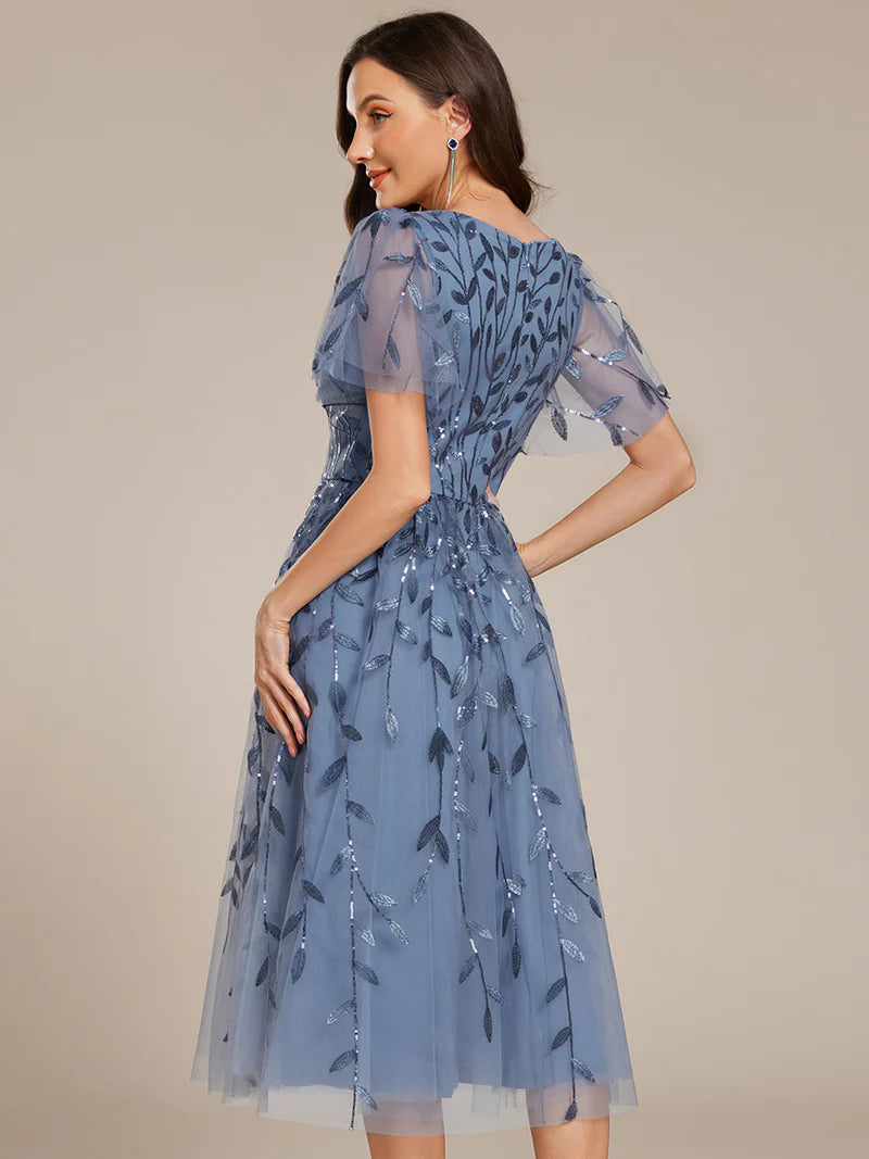 Exquisite midi length Dusty Blue dress with ruffled sleeves, tulle fabric, sequin details, and embroidery