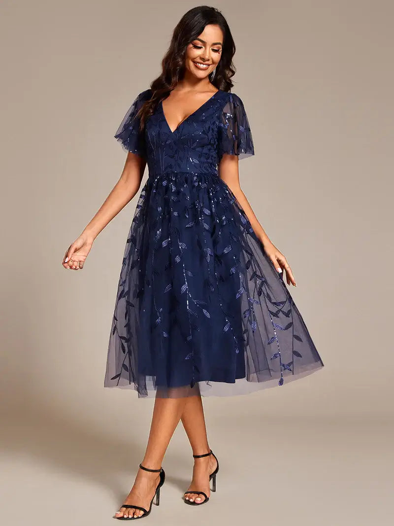 Exquisite midi length Navy Blue dress with ruffled sleeves, tulle fabric, sequin details, and embroidery
