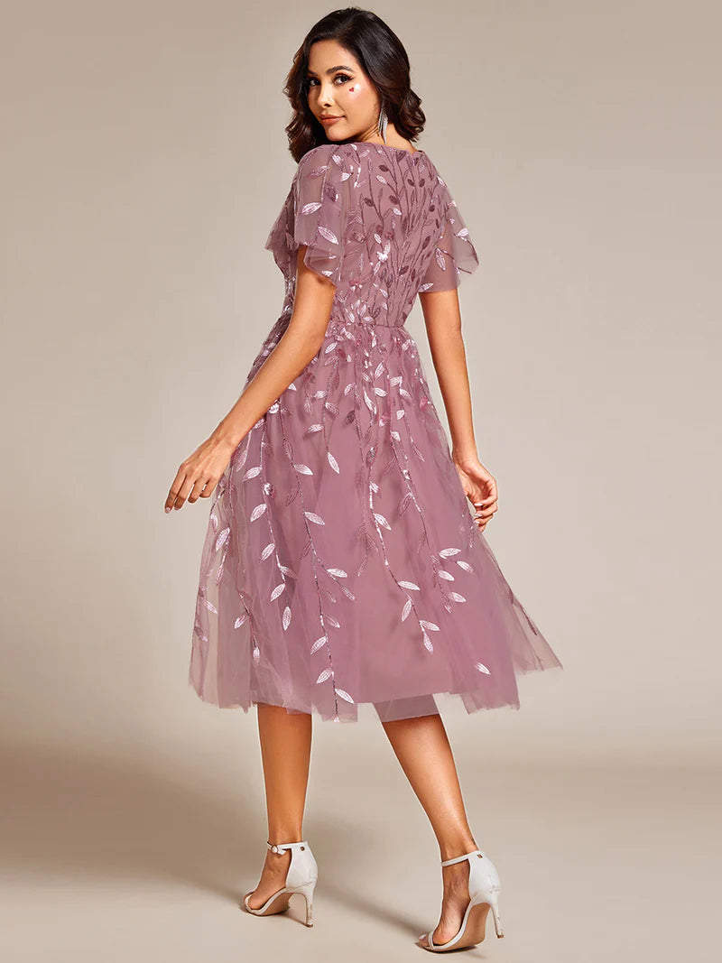 Exquisite midi length Orhidea dress with ruffled sleeves, tulle fabric, sequin details, and embroidery