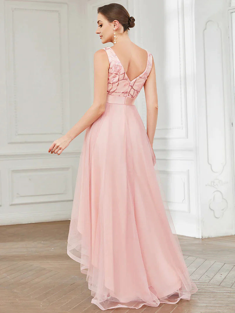 High-low pink tulle prom dress with V-neck and sequin appliques, perfect for formal events