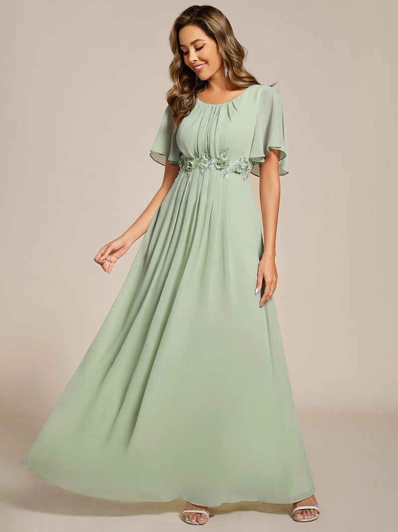 Mint green a-line floor-length evening dress with short sleeves, pleated skirt, and applique embellishments