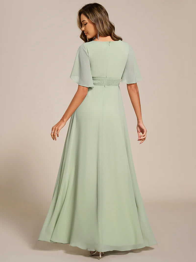 Mint green a-line floor-length evening dress with short sleeves, pleated skirt, and applique embellishments