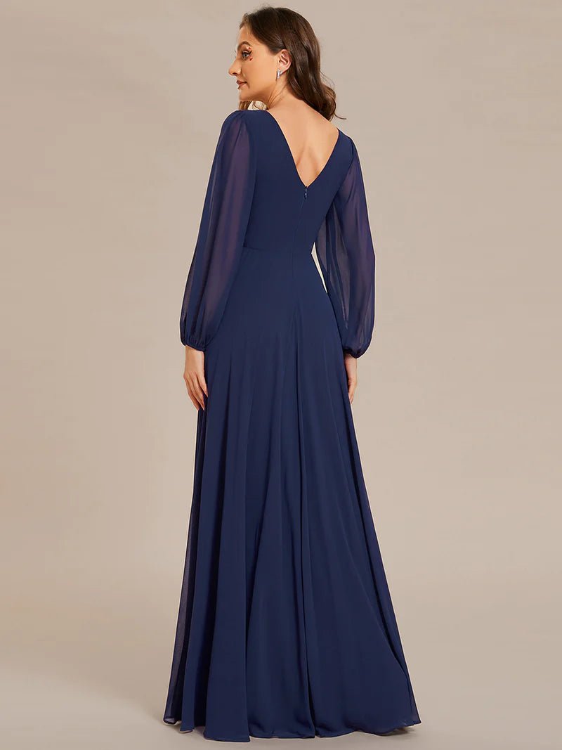 Navy blue elegant chiffon guest dress with V-neckline, long sleeves, and a fitted waist