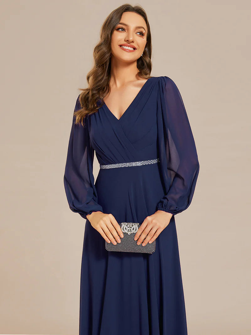 Navy blue elegant chiffon guest dress with V-neckline, long sleeves, and a fitted waist