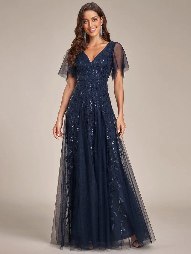 Navy blue romantic shimmery evening gown with V-neckline, ruffle sleeves, and maxi length