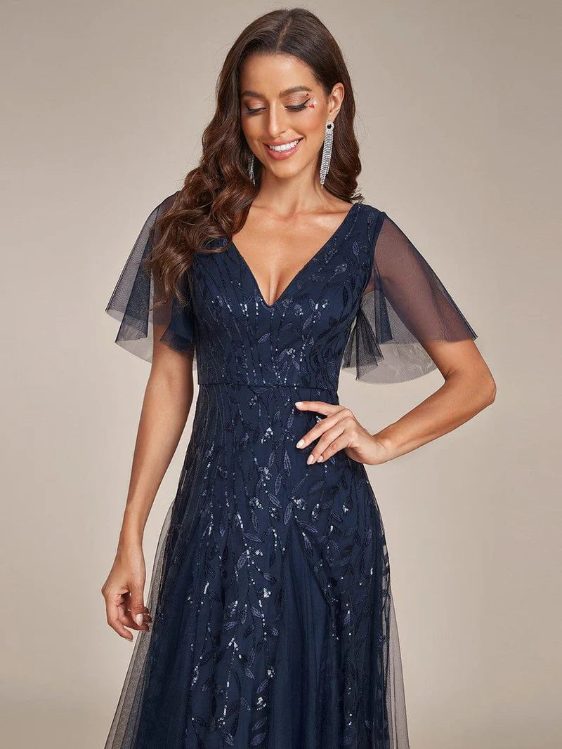 Navy blue romantic shimmery evening gown with V-neckline, ruffle sleeves, and maxi length
