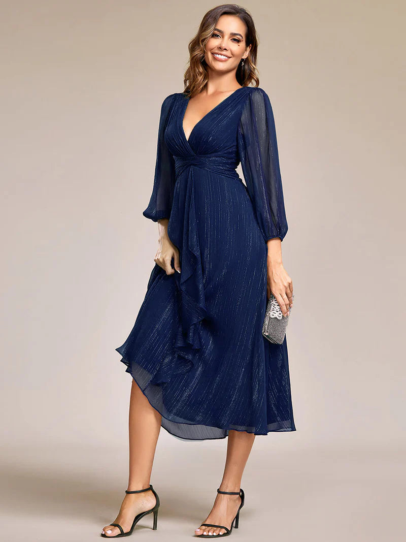 Navy blue elegant shiny chiffon wedding guest dress with long sleeves and flowing silhouette