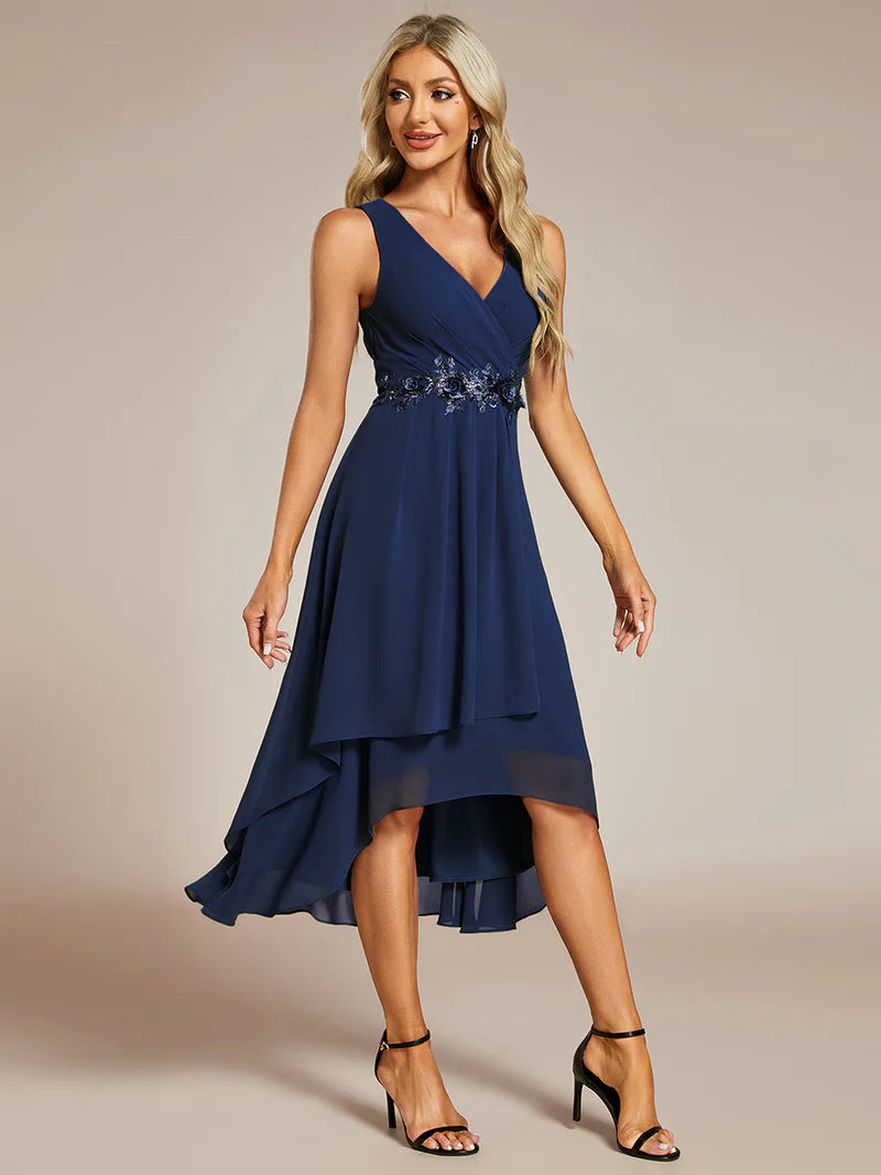 Navy blue tea-length chiffon wedding guest dress with V-neckline and delicate appliqués