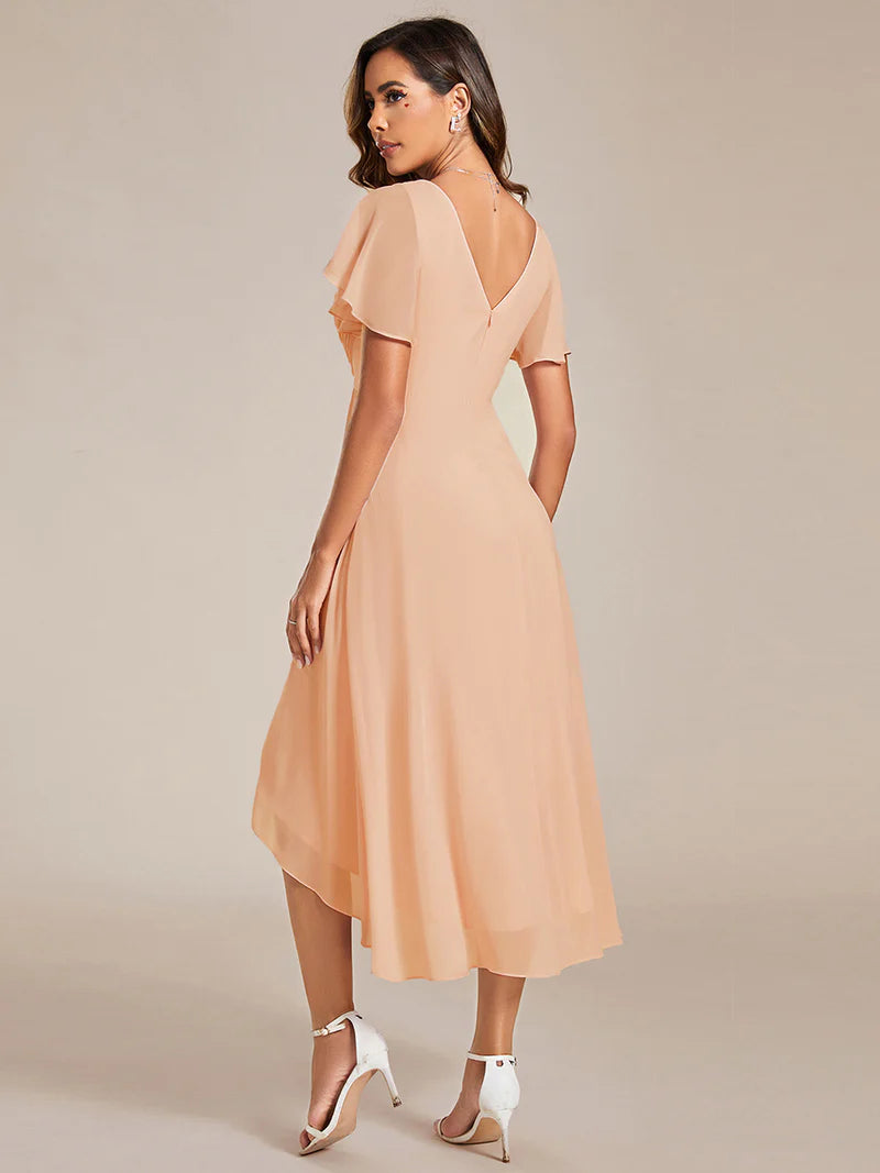 Peach elegant chiffon wedding guest dress with pleated bodice and ruffle detailing