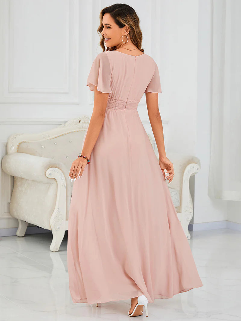 Round neck pink bridesmaid gown in a pleated design for elegant wedding looks