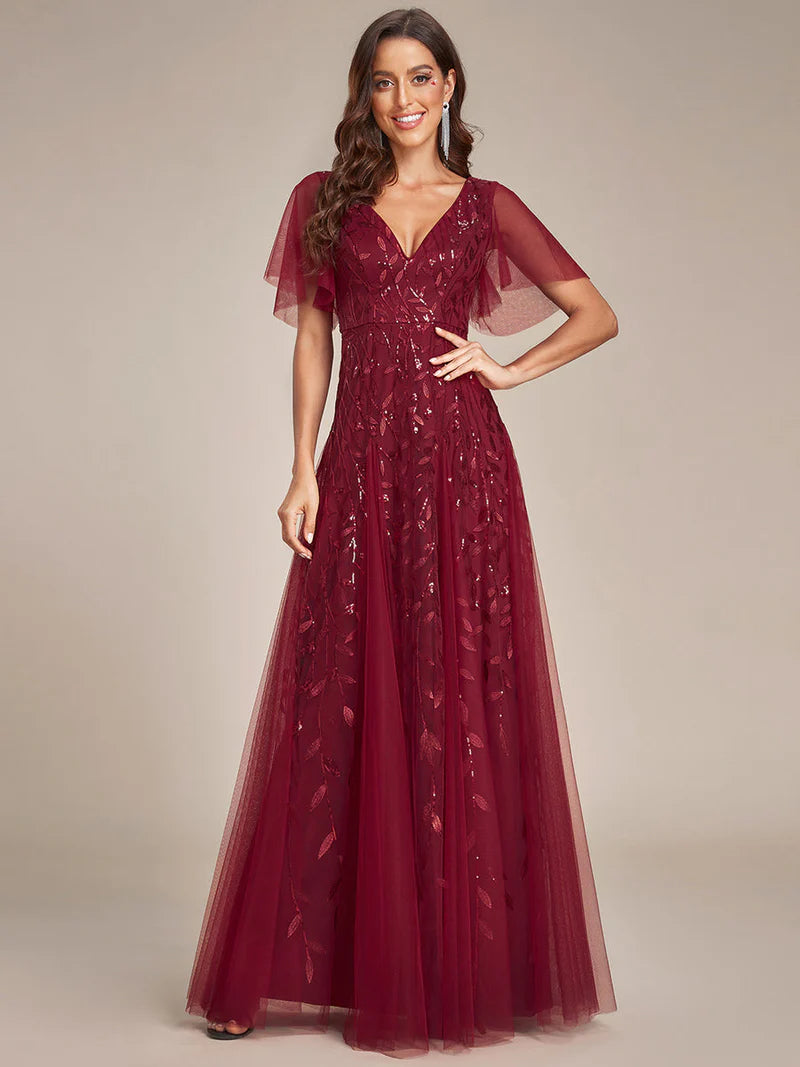 Romantic shimmery evening gown with V-neckline, ruffle sleeves, and floor-length maxi silhouette burgundy dress