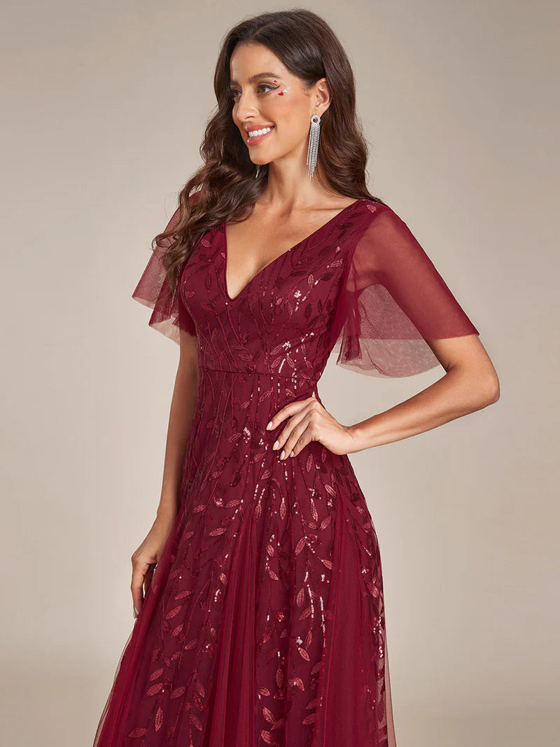Romantic shimmery evening gown with V-neckline, ruffle sleeves, and floor-length maxi silhouette burgundy dress