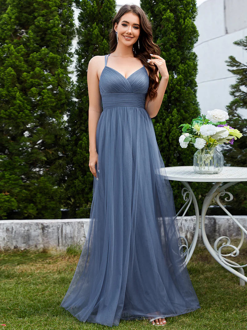 Romantic tulle dusty blue bridesmaid dress with spaghetti straps, lace halter neckline, and open back