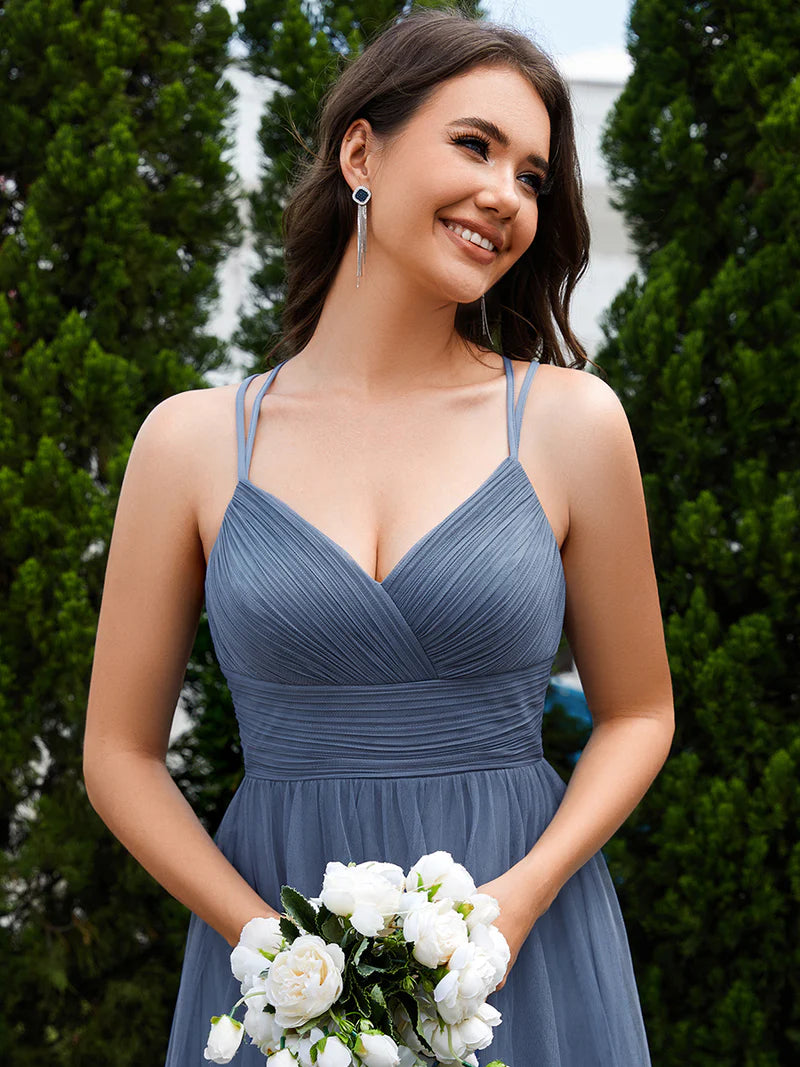 Romantic tulle dusty blue bridesmaid dress with spaghetti straps, lace halter neckline, and open back