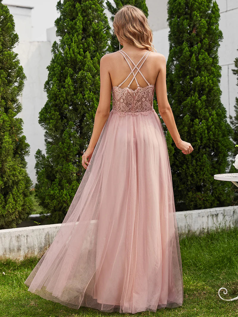 Romantic pink bridesmaid dress with spaghetti straps, lace halter neckline, and open back