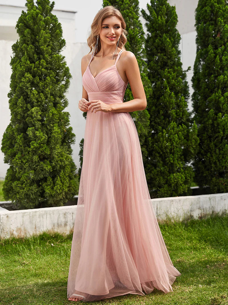 Romantic pink bridesmaid dress with spaghetti straps, lace halter neckline, and open back