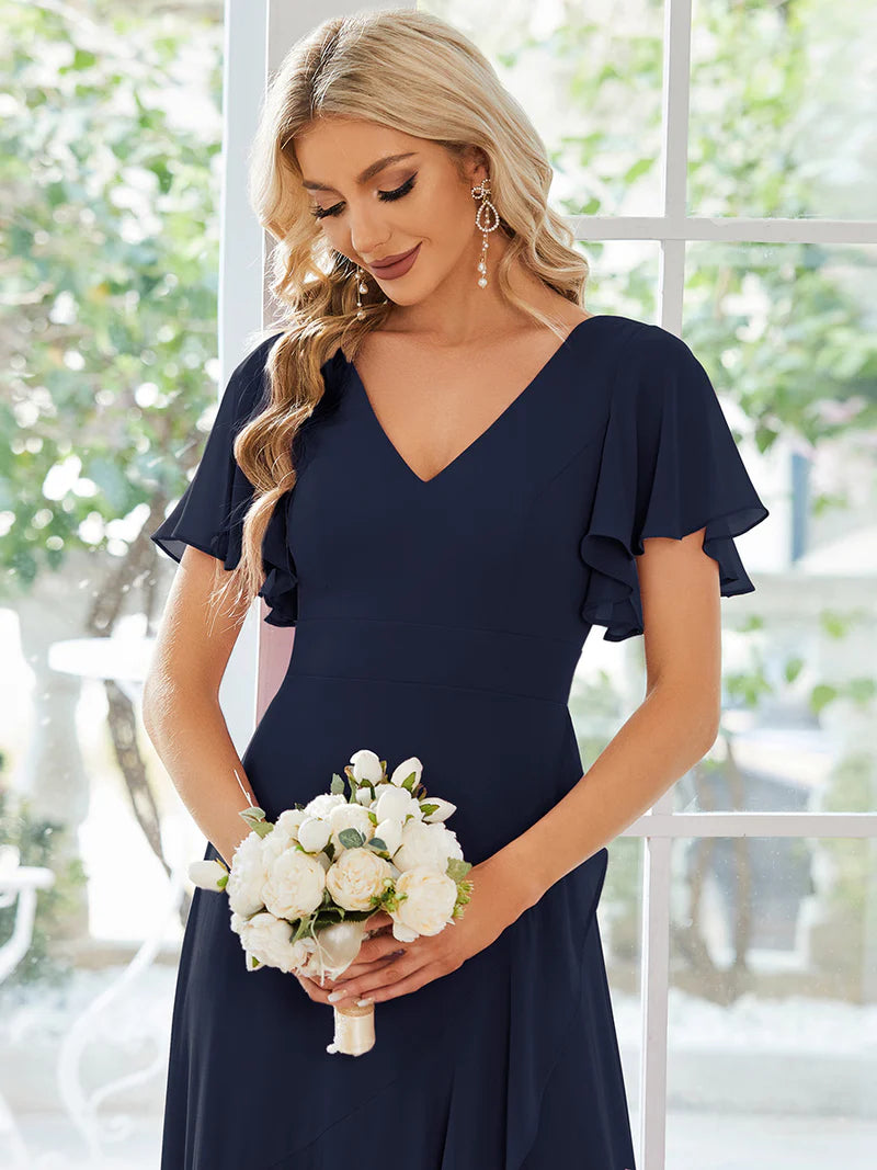 Elegant navy blue chiffon high-low gown for bridesmaids featuring V-neck and soft ruffles