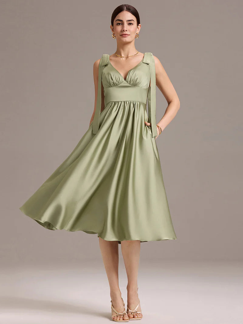 Sage green satin midi dress with V-neckline, tie-shoulder straps, and sleeveless style