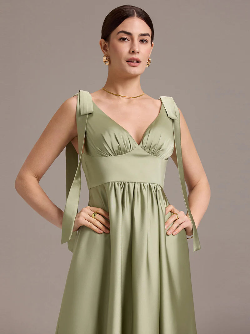 Sage green satin midi dress with V-neckline, tie-shoulder straps, and sleeveless style