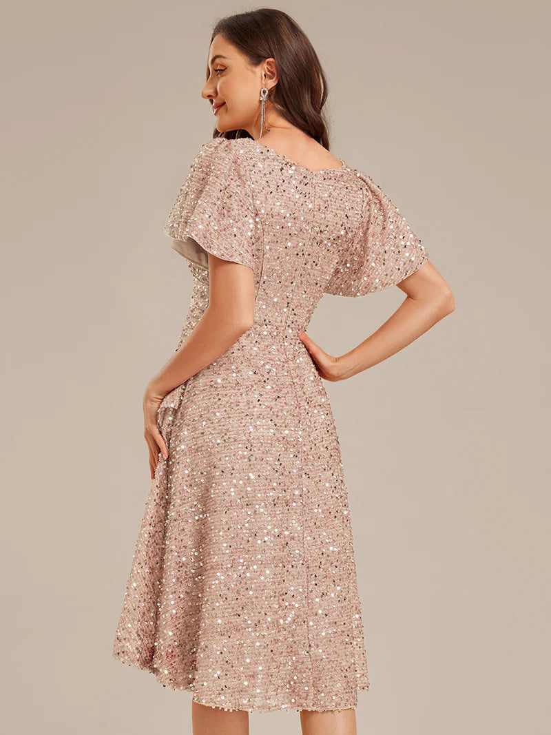 Elegant sequin high-low formal champagne dress featuring short ruffle sleeves and a deep V-neckline – ideal for weddings, galas, or prom nights.