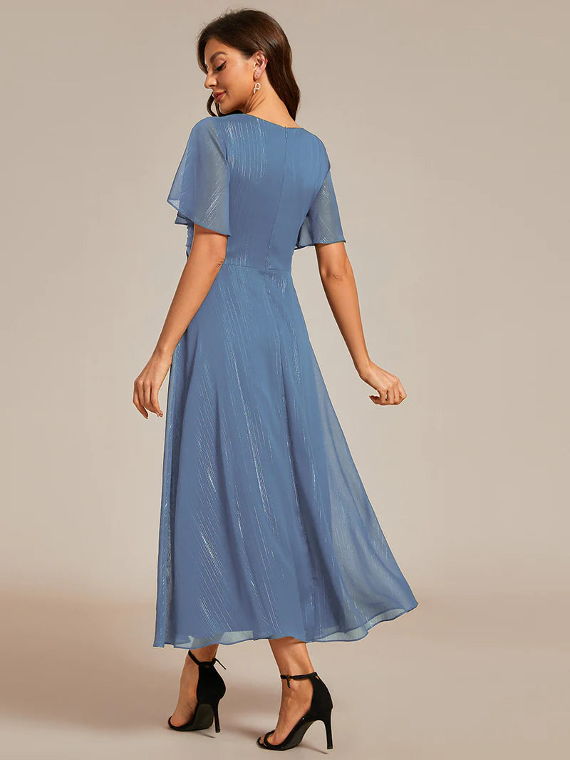 Shimmering V-neck tea length dusty blue dress with short sleeves, perfect for wedding guests