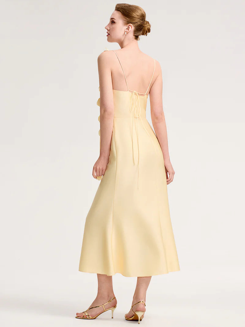 Woman wearing a light yellow dress on a white background