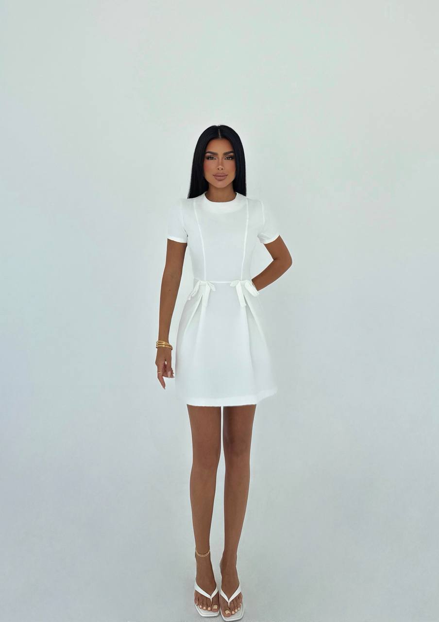 Simple and elegant white mini dress with waist bow details for a casual look
