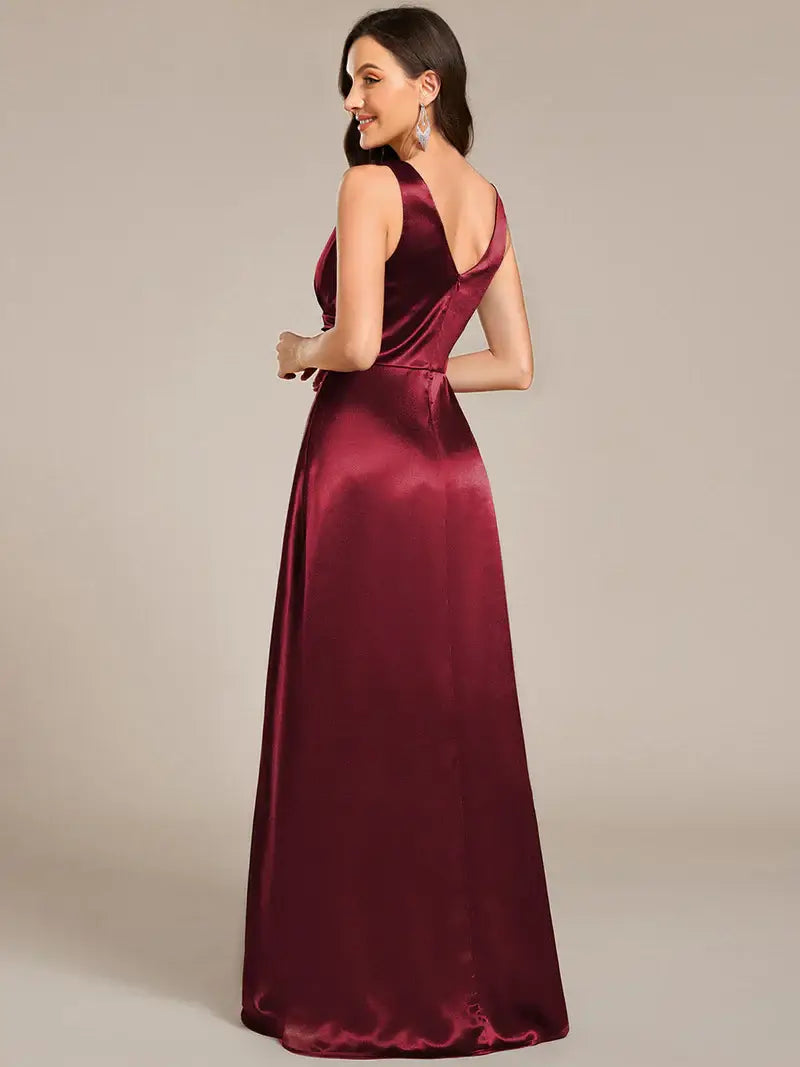 Burgundy satin evening gown on a plain background