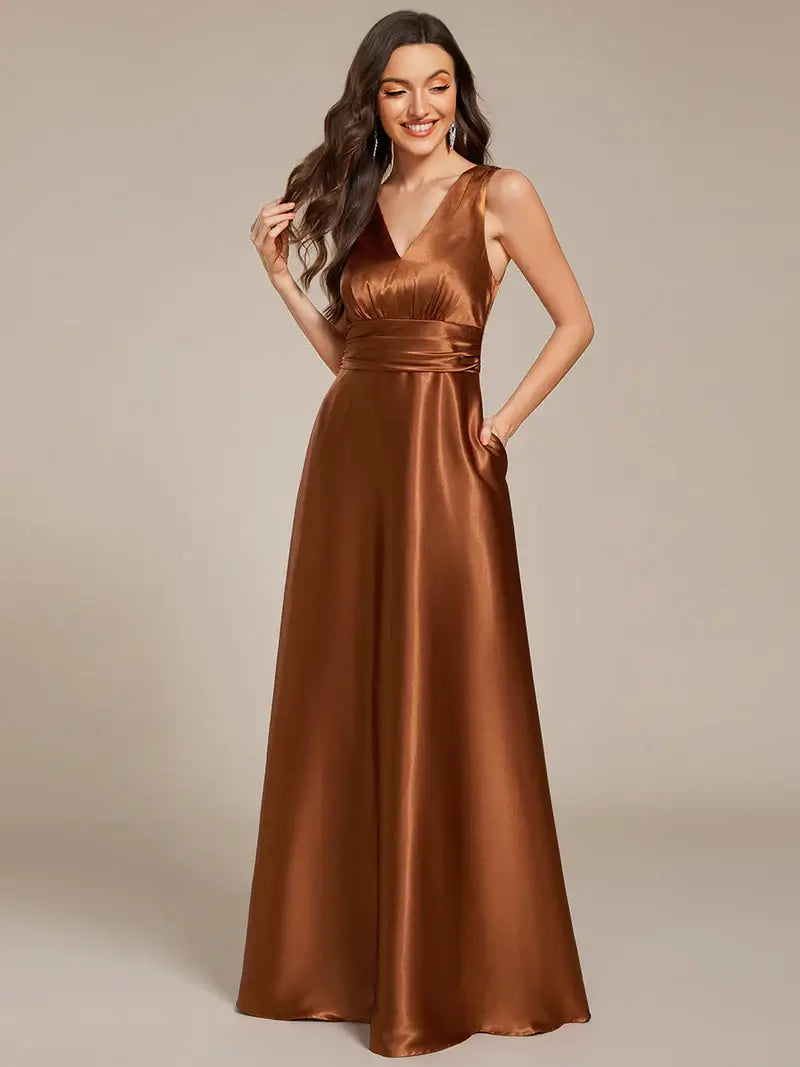 Woman wearing a Copper satin gown against a beige background