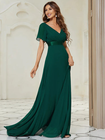 Woman wearing a Dark green evening gown in an elegant interior setting
