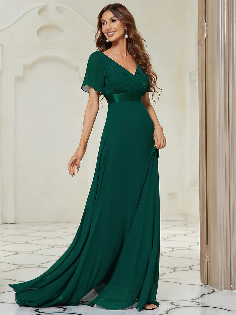 Woman wearing a Dark green evening gown in an elegant interior setting