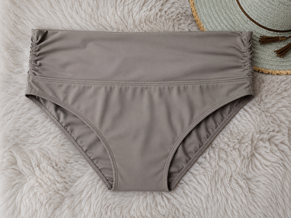 Brown bikini bottom on a textured surface